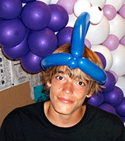 boy wearing a balloon hat