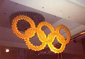 Olympic style rings with lined with lights usedn a focal decoration for the conclusion of a corporate olympic competition